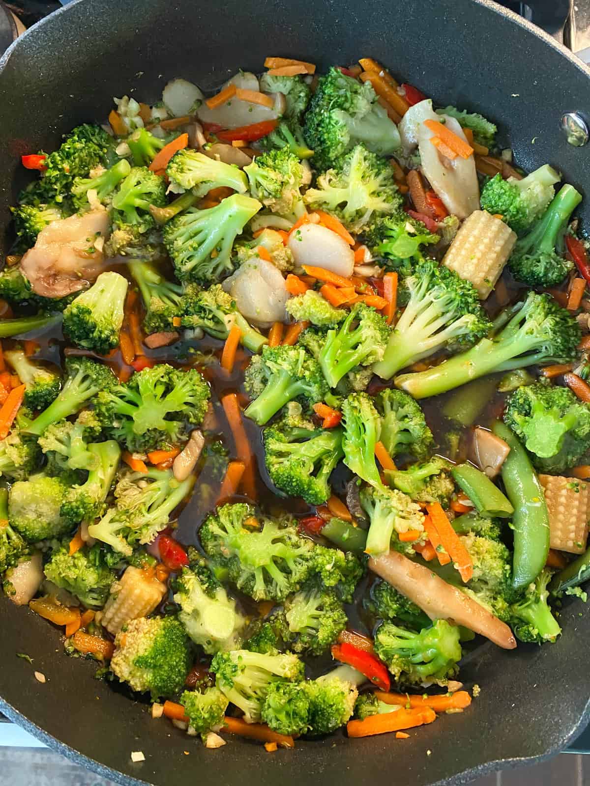 Cooked stir fry vegetables in a pan.