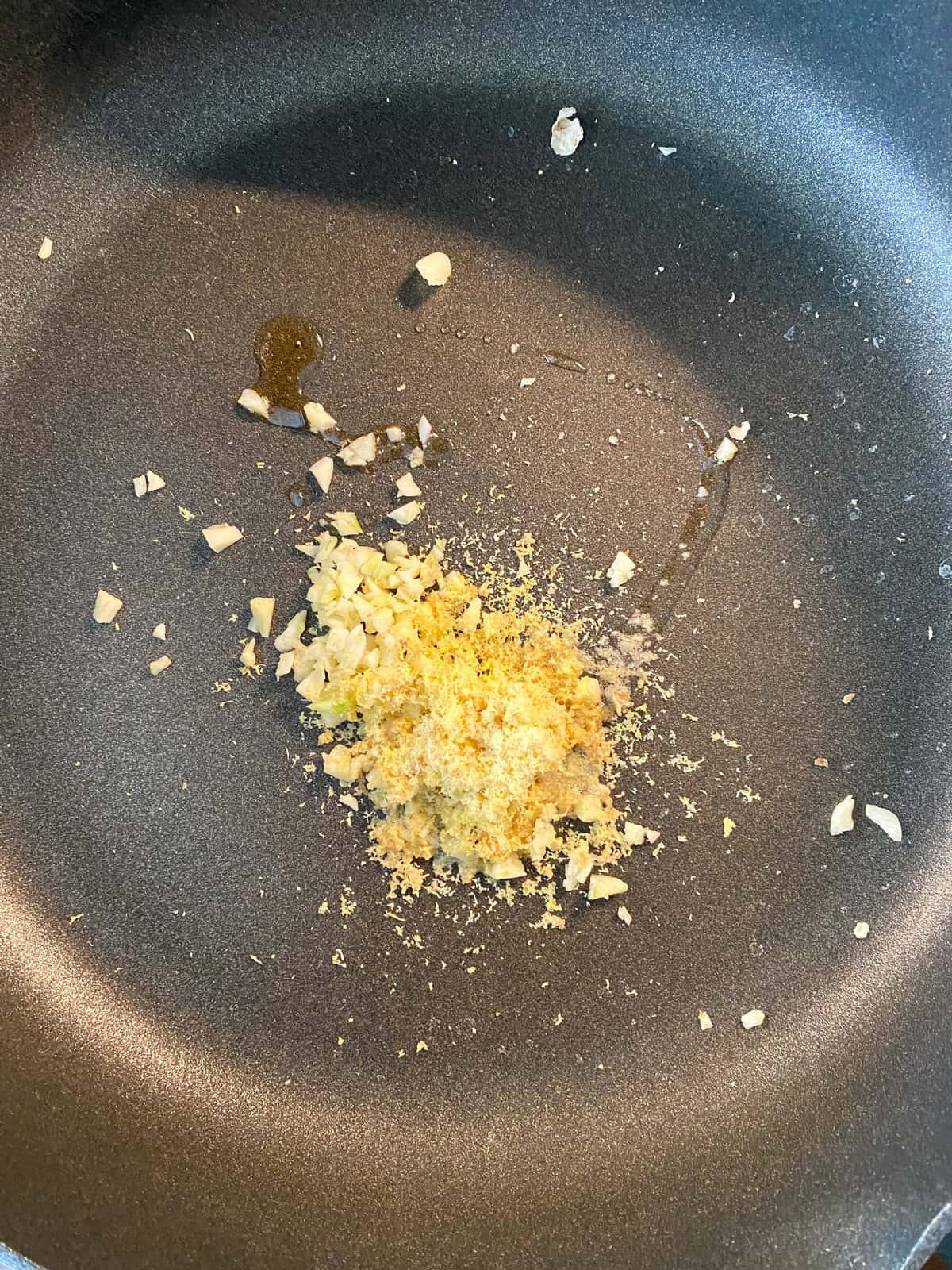 Minced garlic and grated ginger in a hot pan with toasted sesame oil.