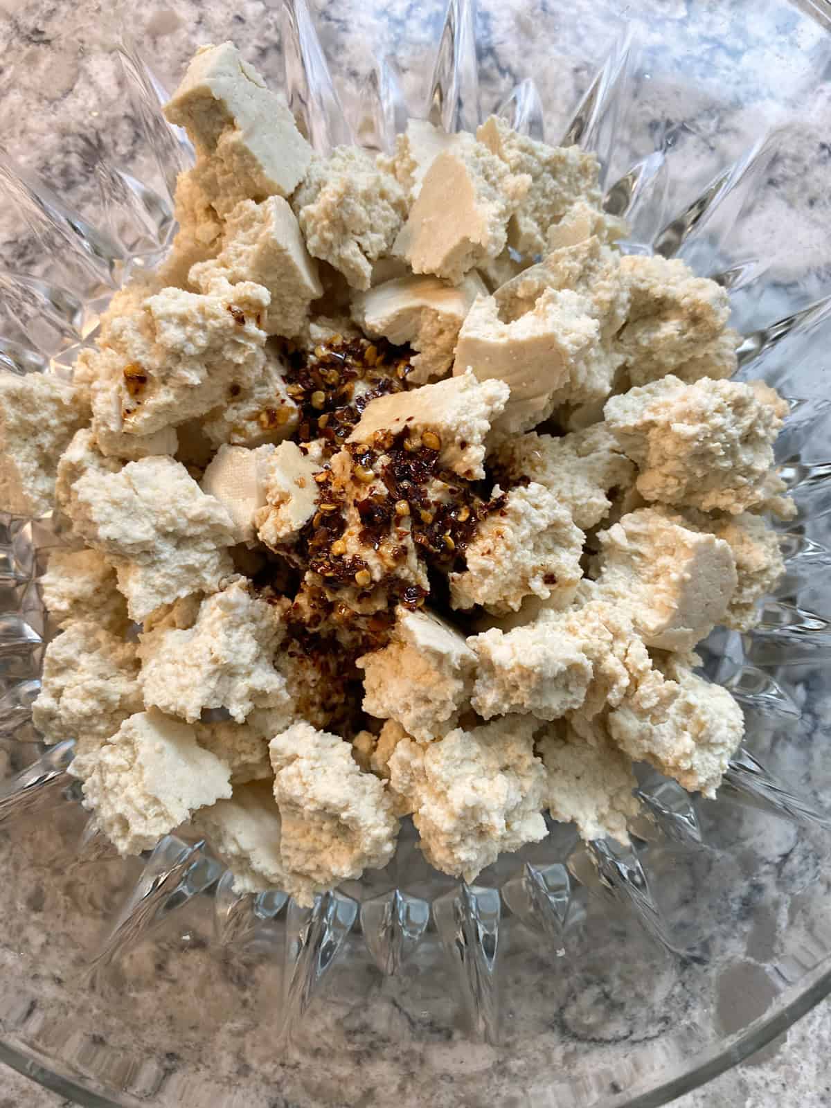 Marinade poured into the bowl with the tofu pieces.
