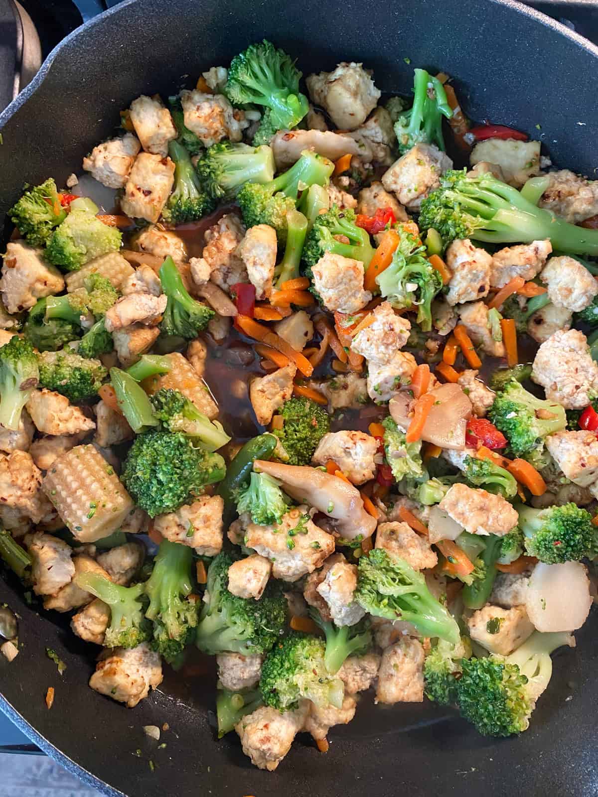 Tofu and stir fry veggies tossed together into a finished dish.