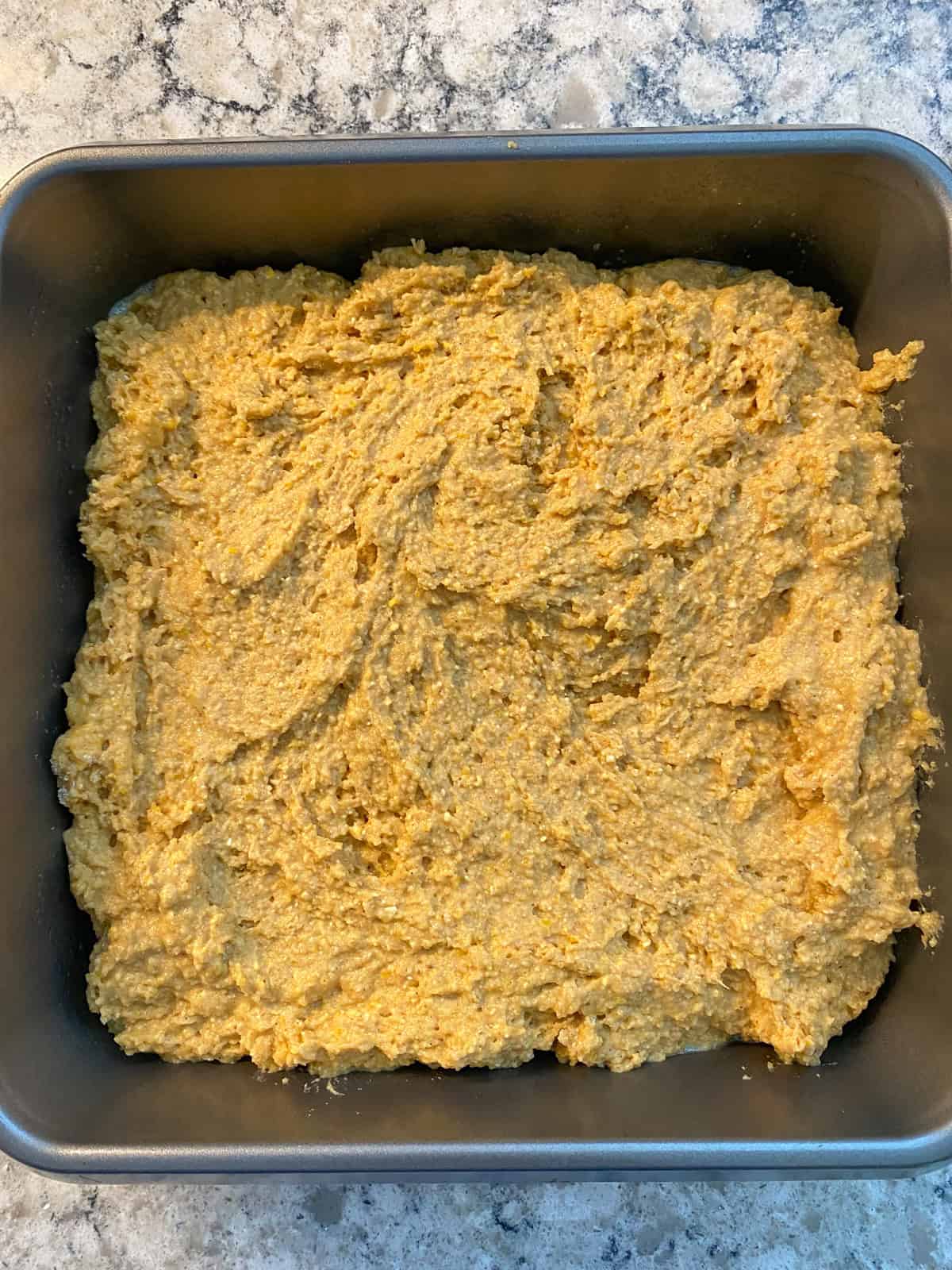 Cornbread batter in a baking pan.