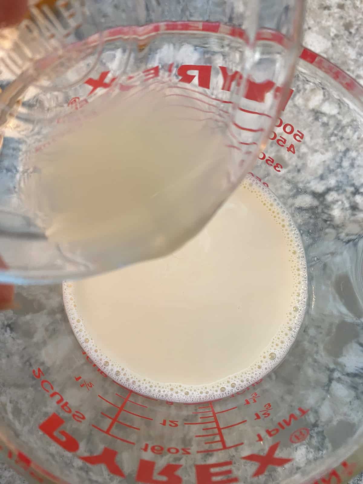 Lemon juice being poured into milk.