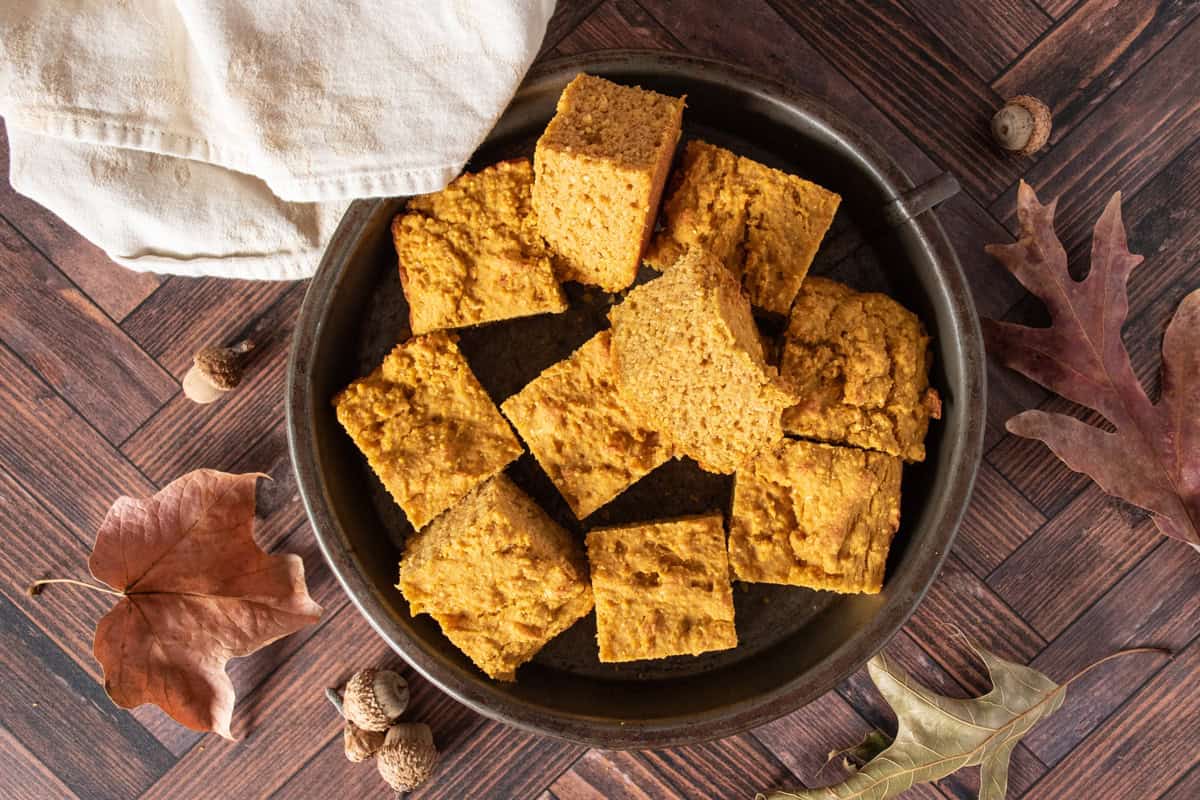 Slices of cornbread in a metal dish.