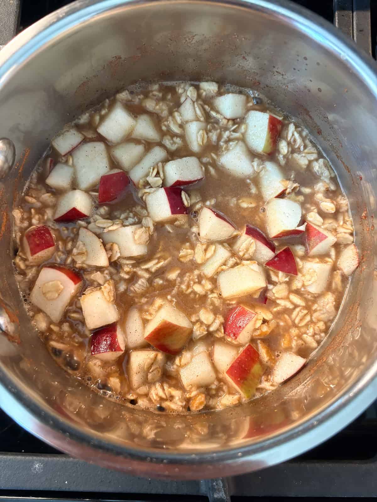 Oatmeal ingredients simmering in a small pot.