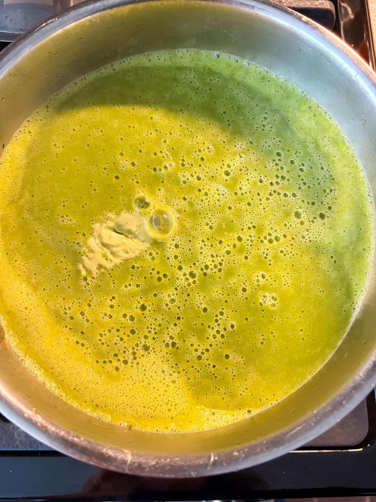 Baking soda added to soup, in a pot.