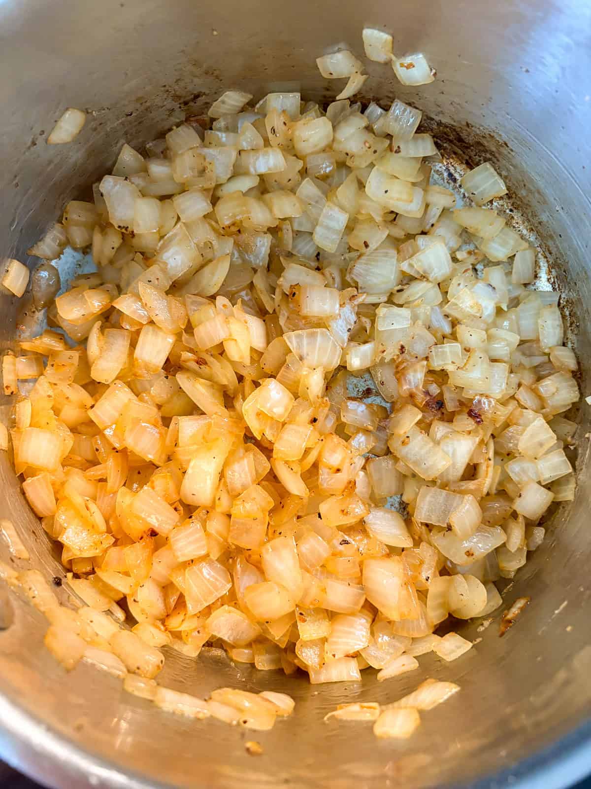 Onions sautéing in a pot.
