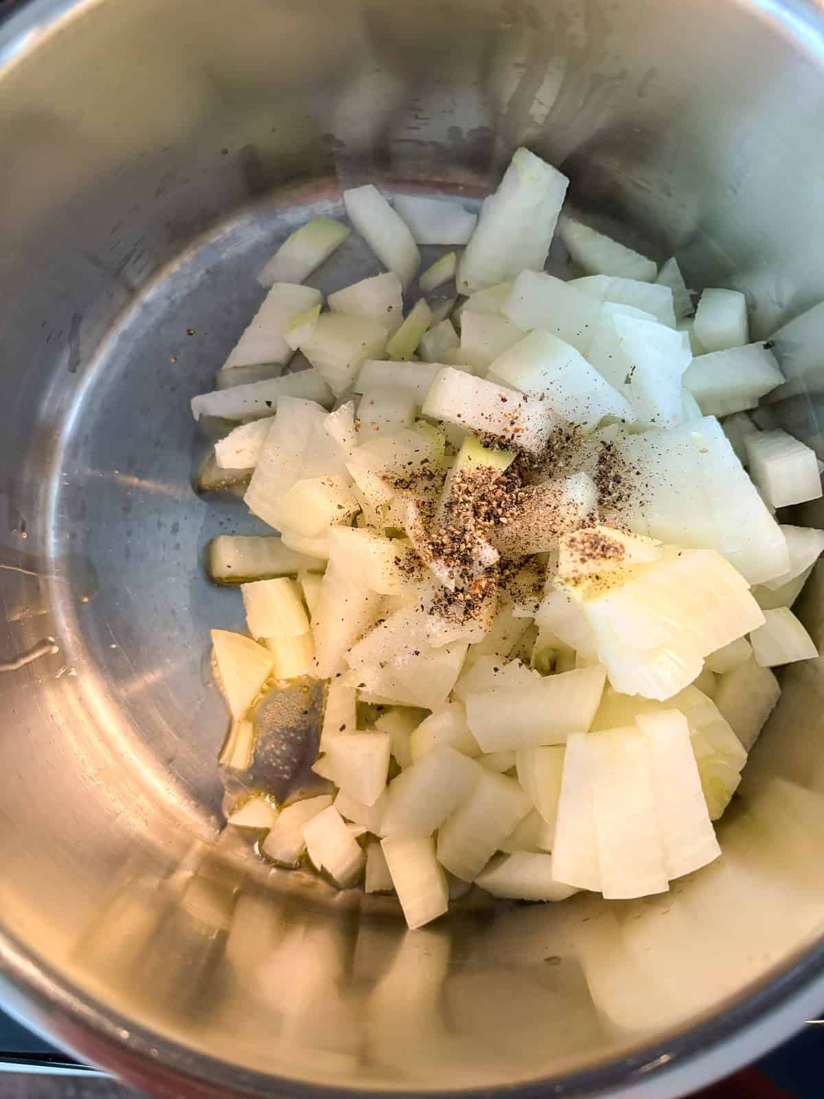 Onions sautéing in a pot.
