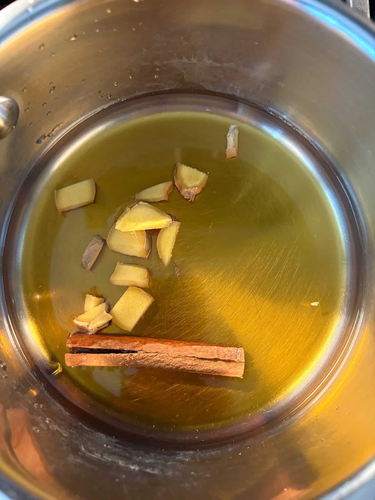 Spiced maple syrup ingredients in a small pot.