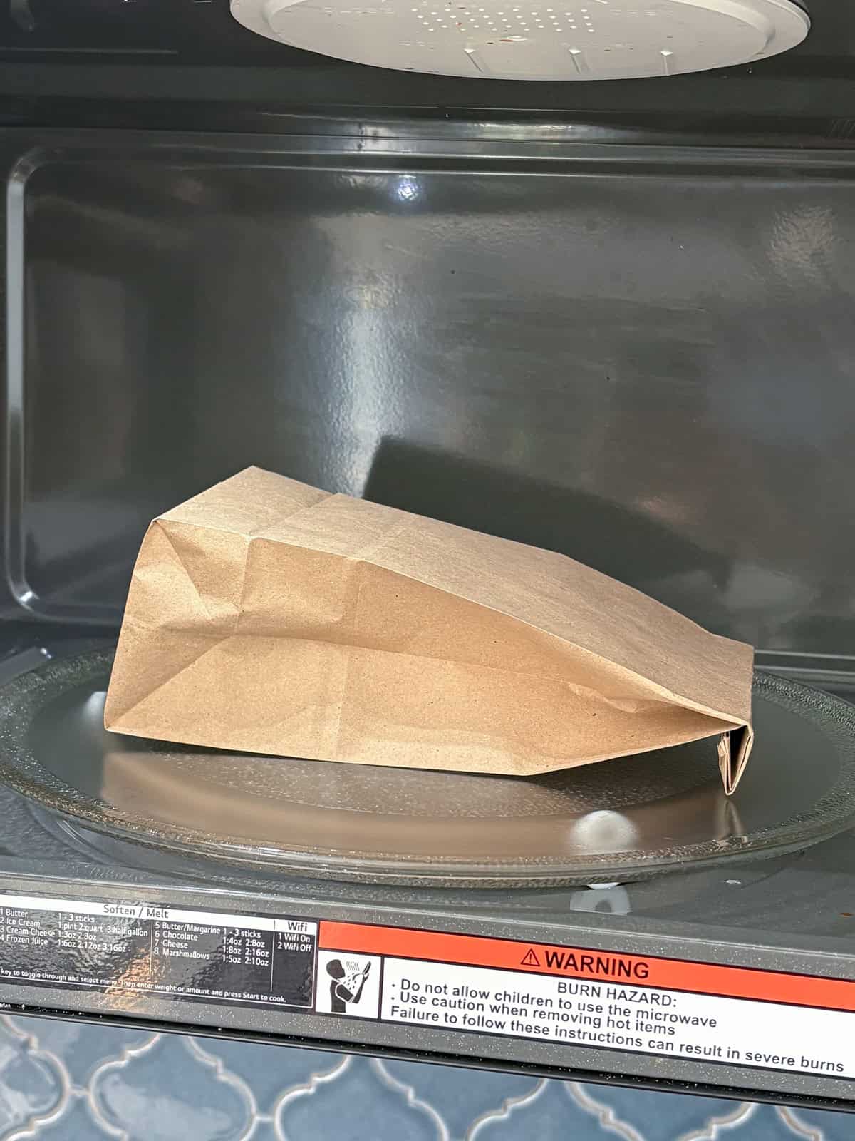 Brown paper lunch bag in the microwave.