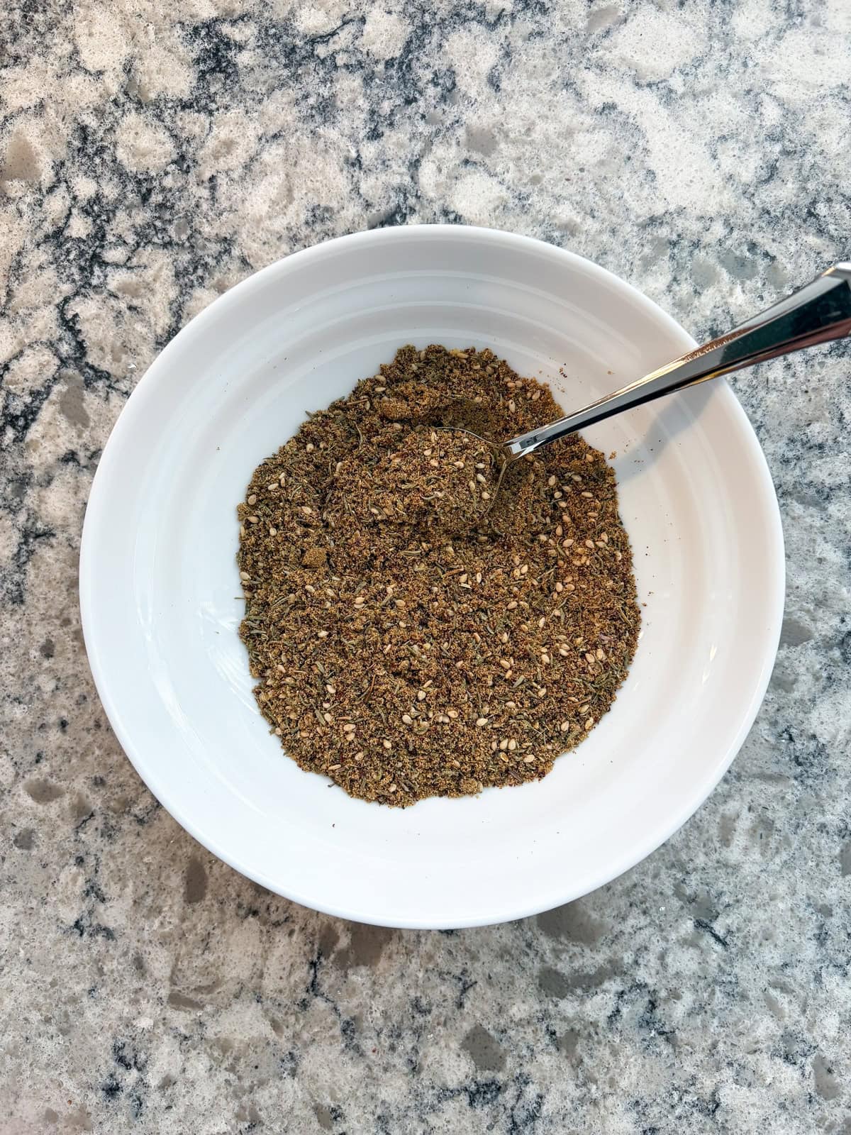 Herbs and spices mixed together in a bowl.