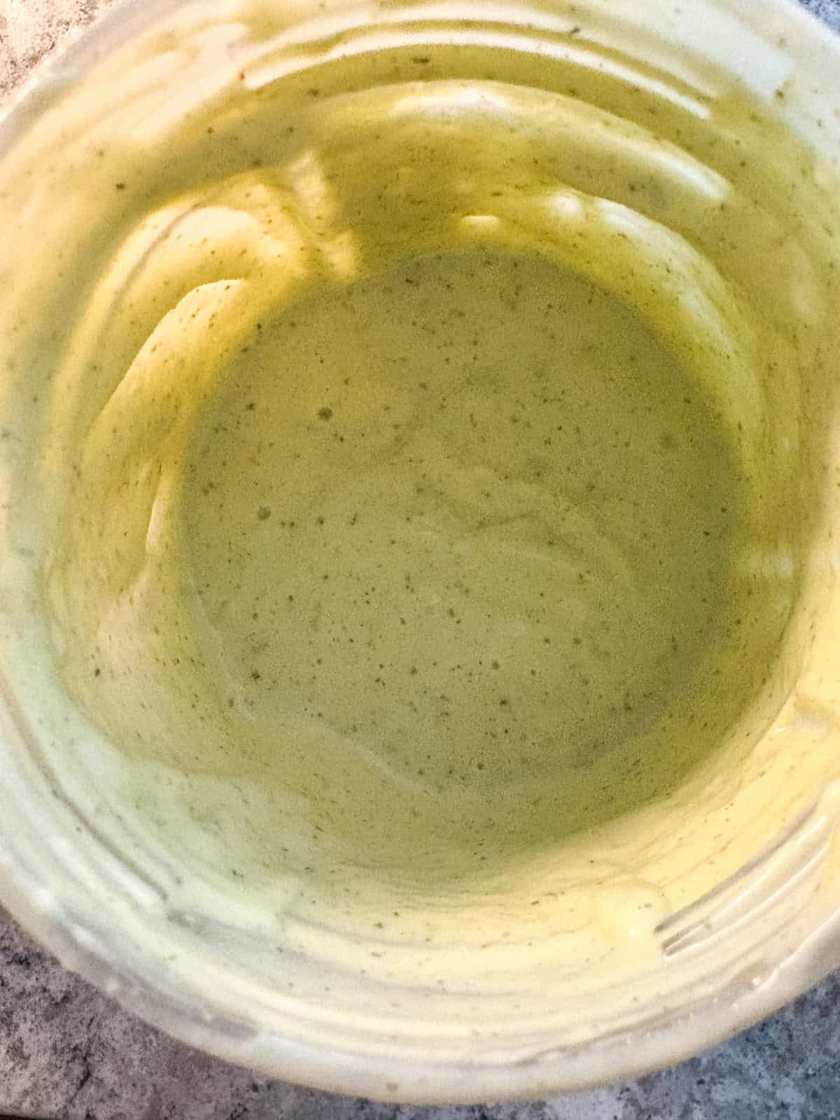 Blended avocado lime ranch dressing, in the blender cup.