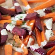 Roasted beets and carrots, cut into large matchsticks, drizzled with a white sauce and sprinkled with chopped dill.