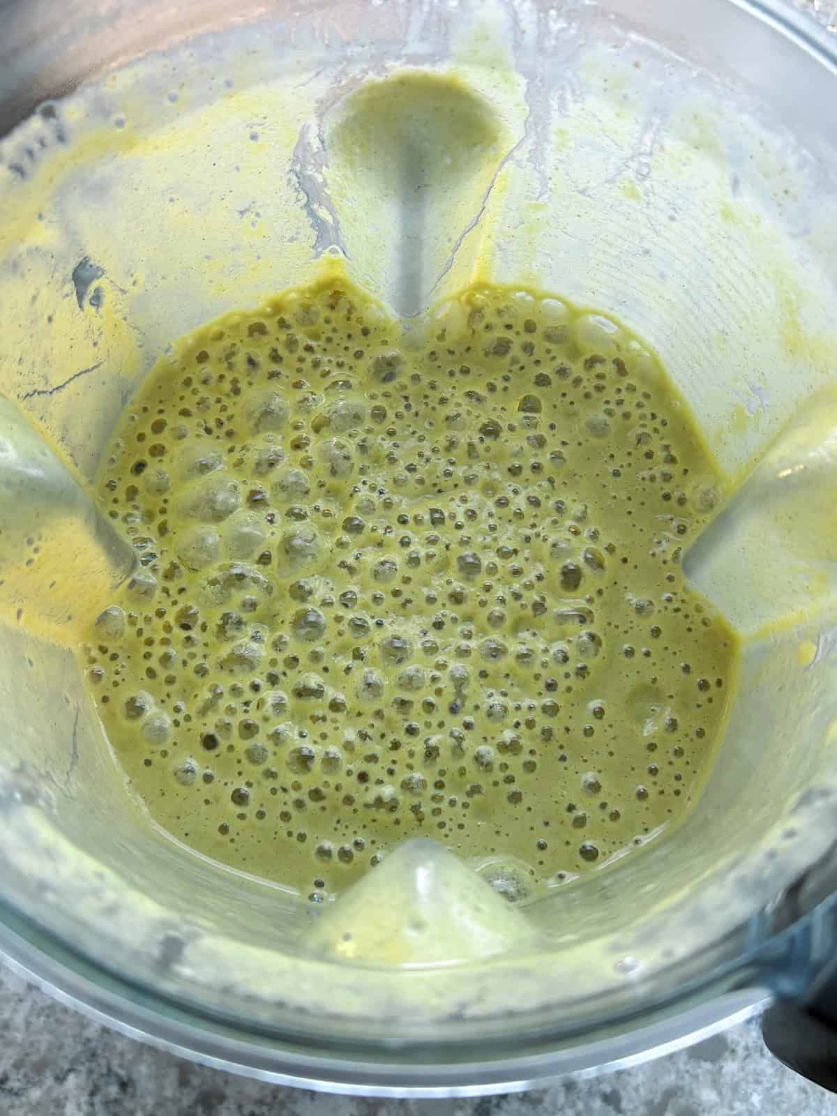 All ingredients except chia seeds blended into a liquid.
