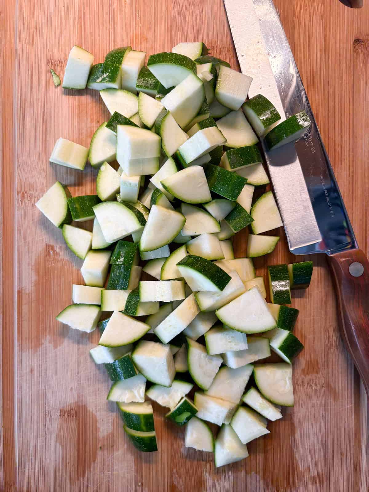 Chopped zucchini on a cutting board.