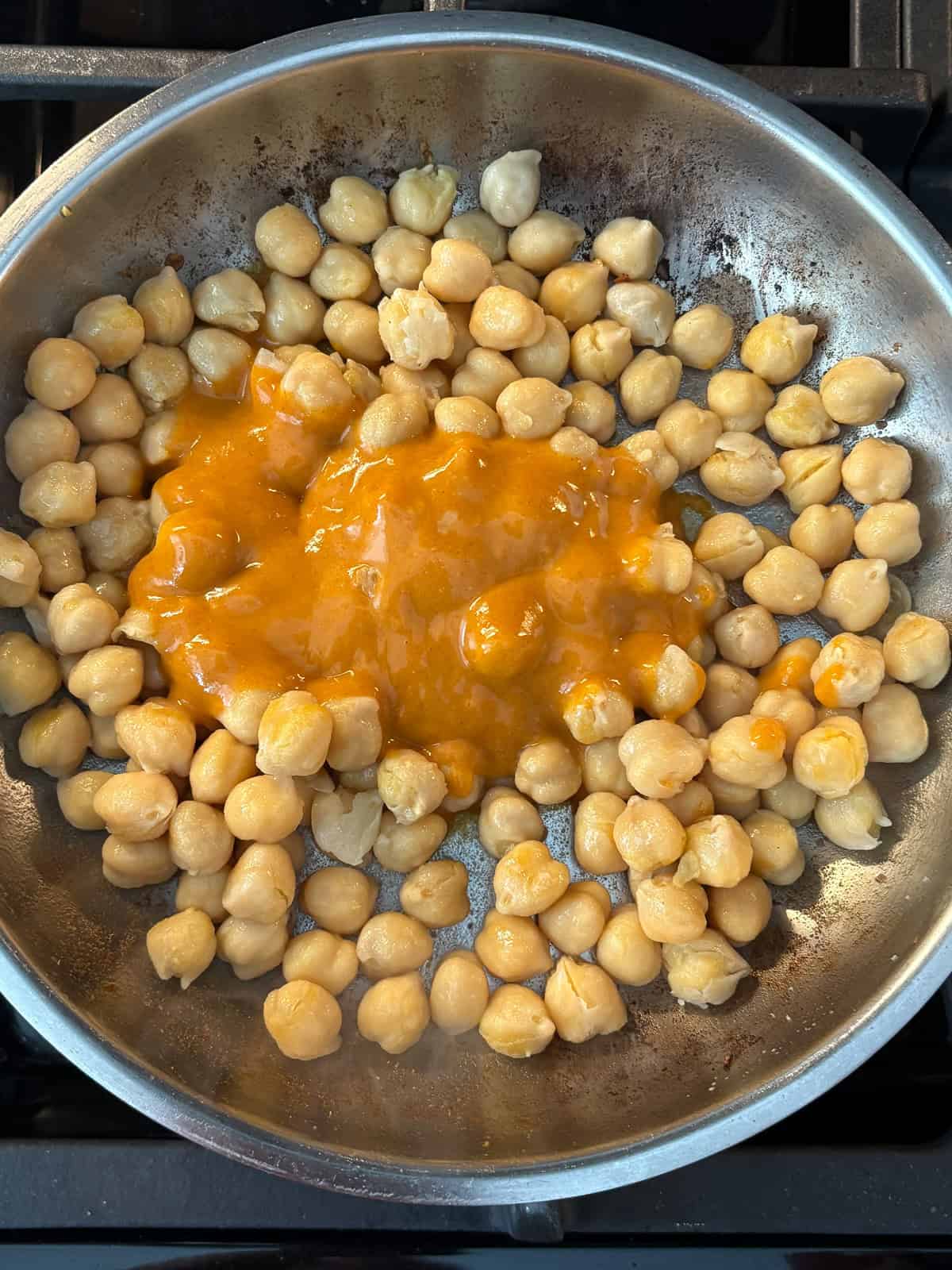 Buffalo sauce added to sautéed chickpeas.