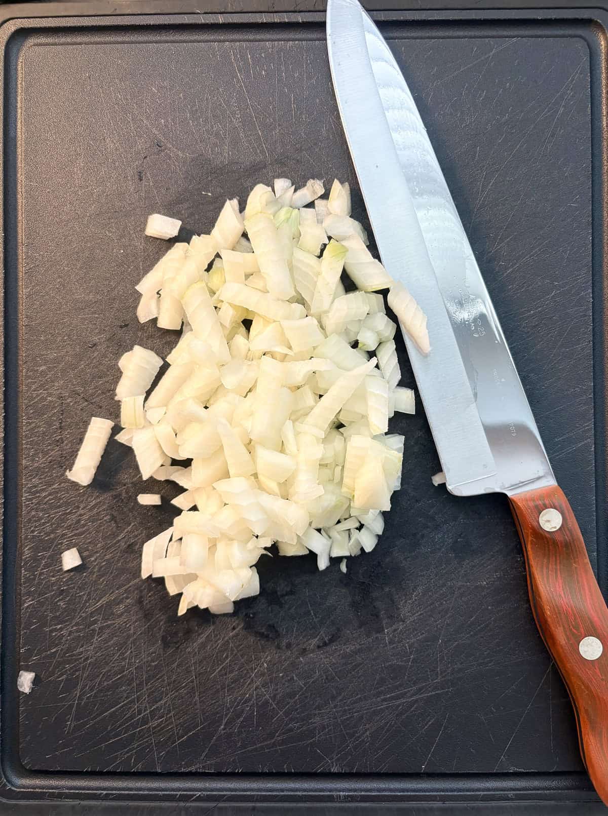 Diced onion on a cutting board.