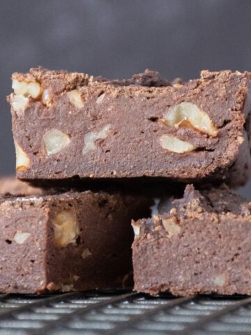 Side view of cut brownies on a cooling rack.