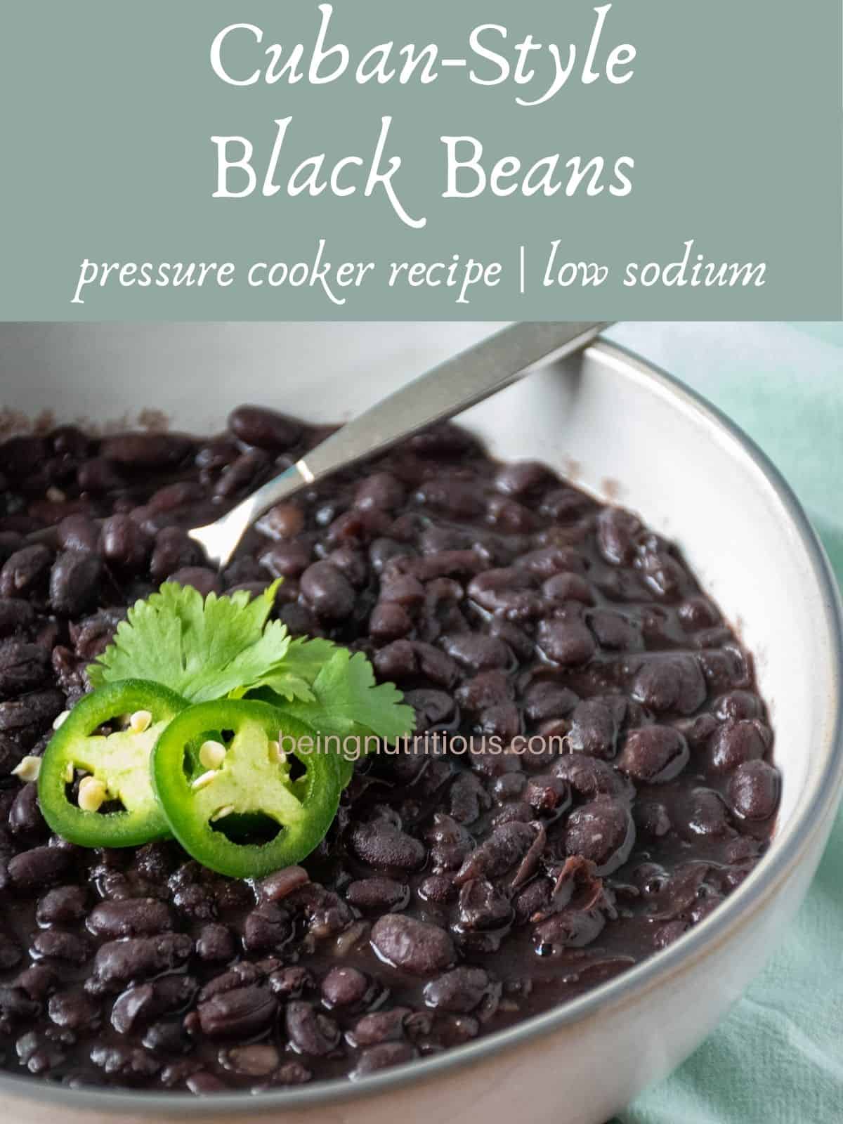 Bowl of black beans garnished with cilantro and jalapeno slices. Text overlay: Cuban-Style Black Beans; pressure cooker recipe; low sodium.