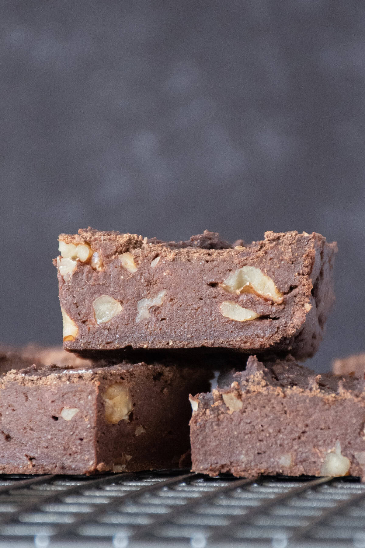 Side view of cut brownies on a cooling rack.