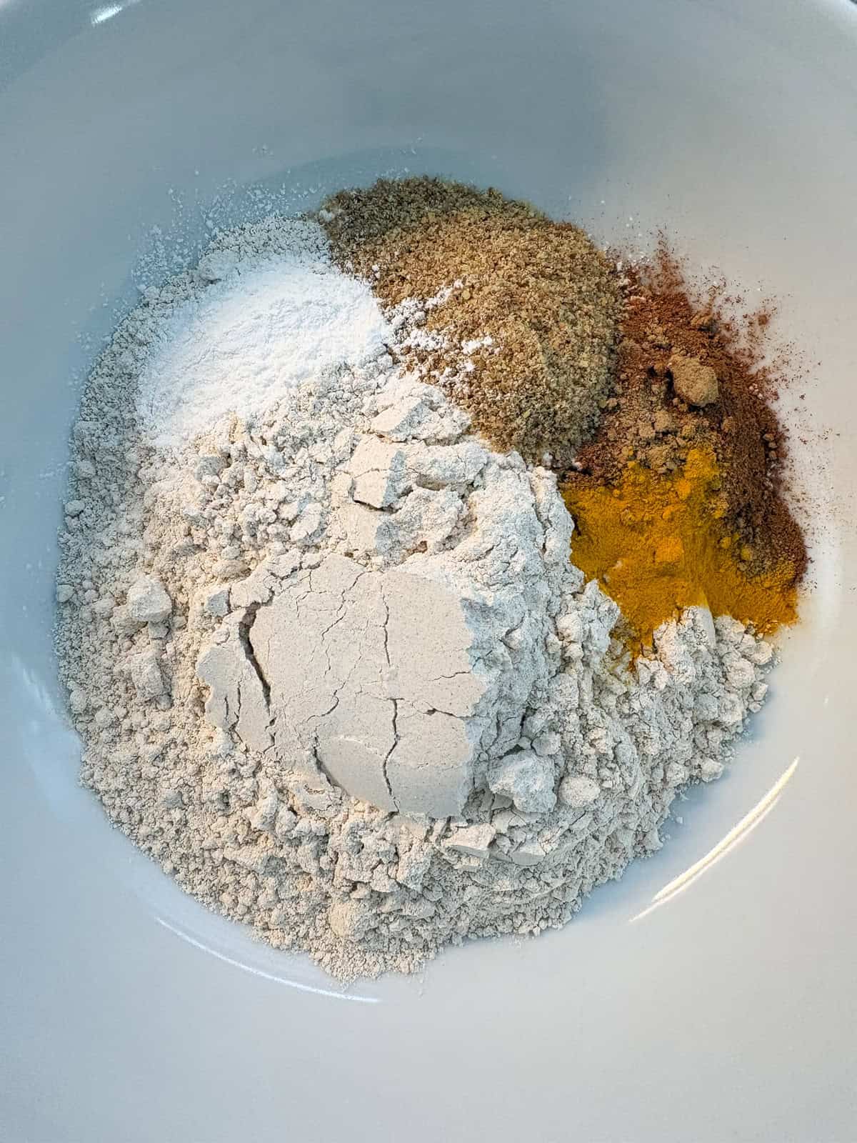 Dry muffin ingredients in a bowl.
