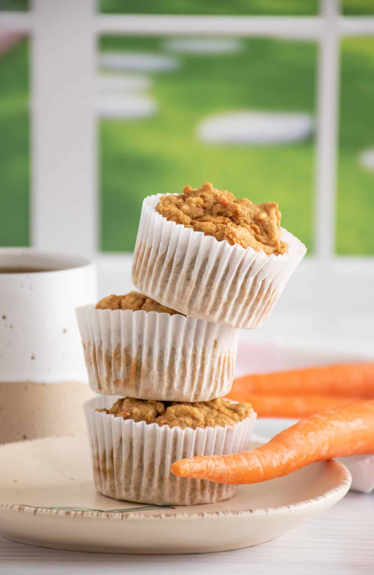 Stack of 3 muffins on a plate.