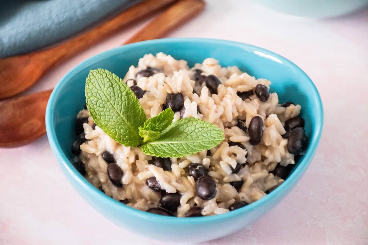 Small bowl of rice and beans, garnished with mint.