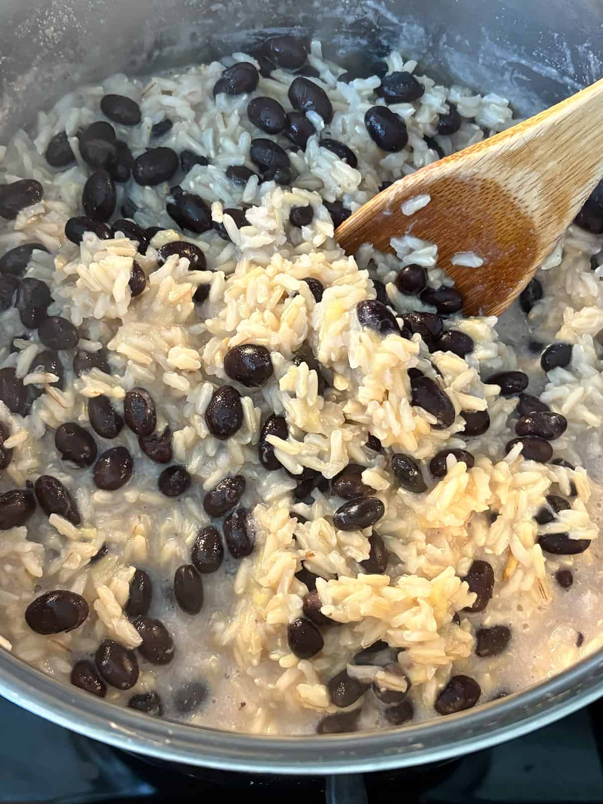 Cooked coconut rice with black beans, in a pot.