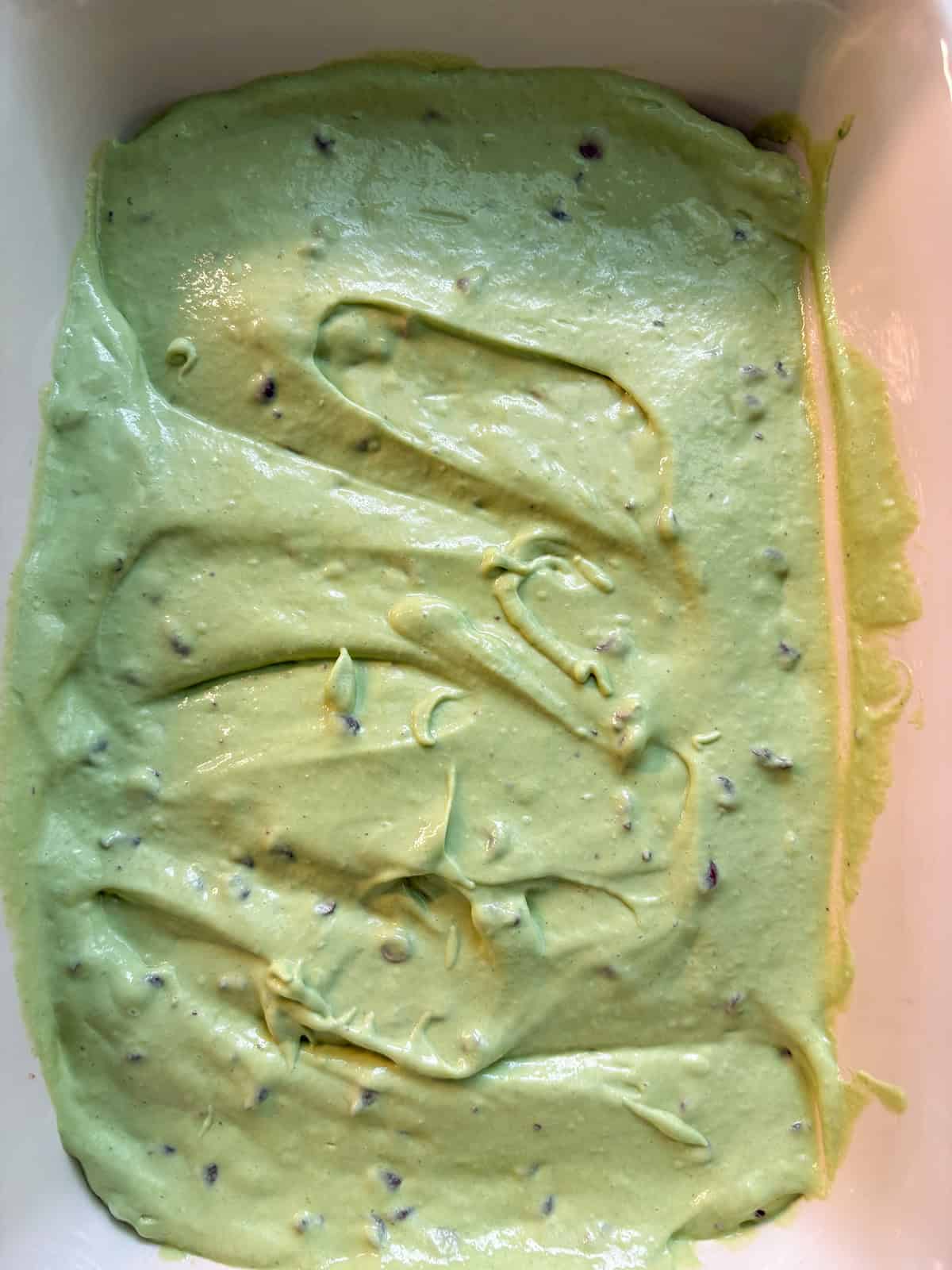 Nice cream with mini chocolate chips mixed in, spread into a pan and ready for freezing.