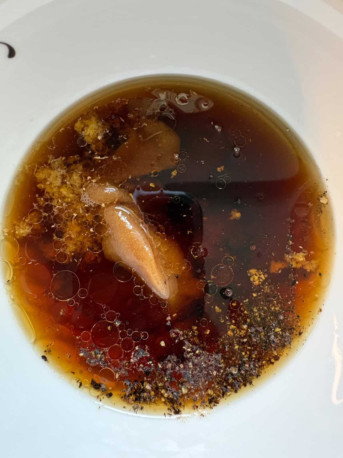 Ingredients for the teriyaki sauce added to a bowl.