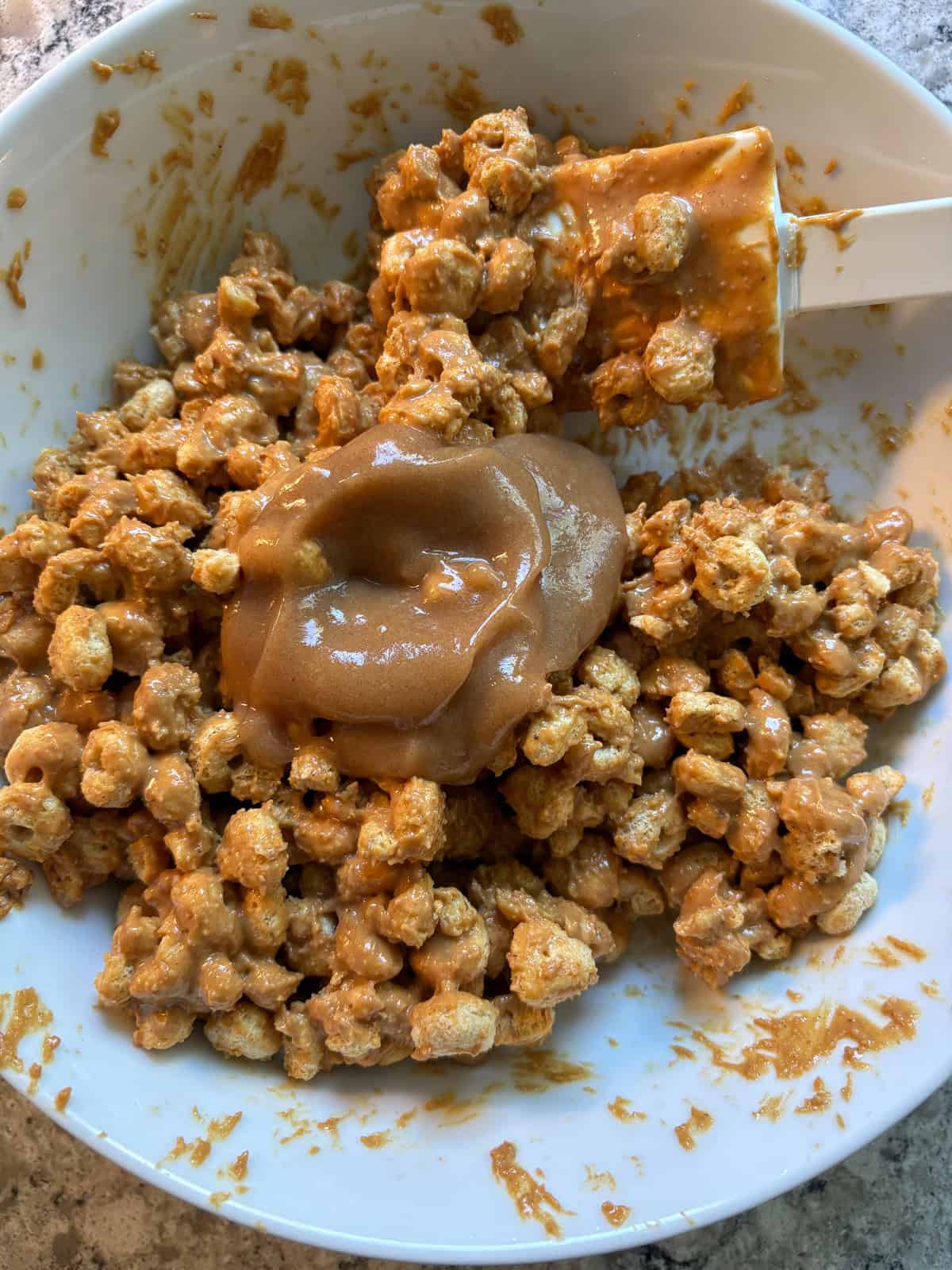 Date paste added to the peanut butter covered cereal.