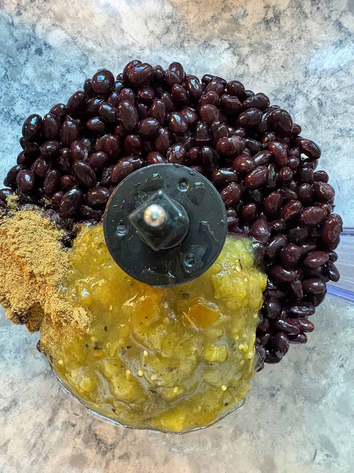 Black beans, salsa, and cumin in a food processor.