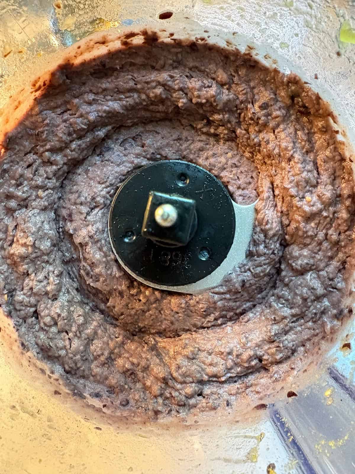 Pureed black bean spread in a food processor.