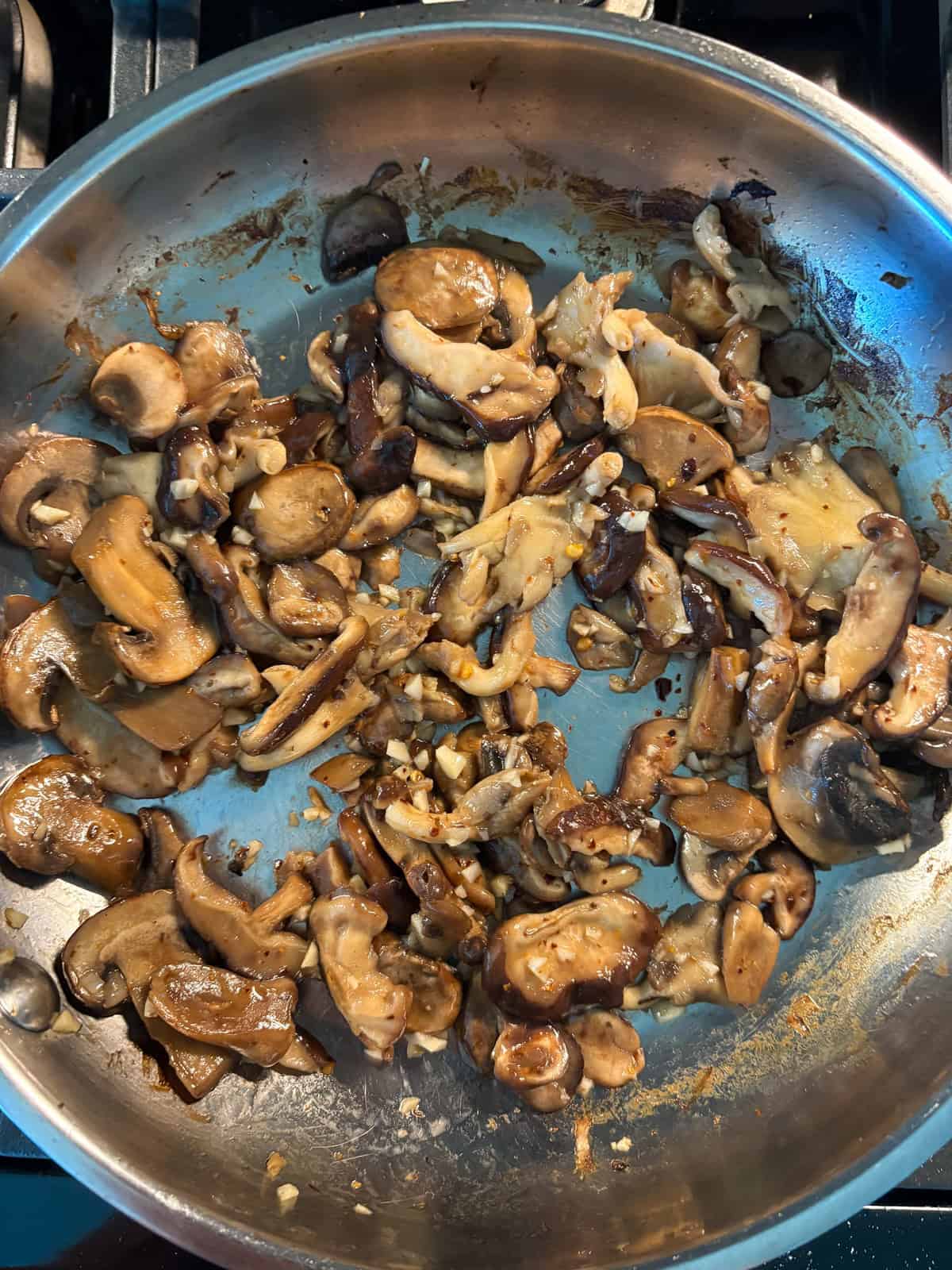 Sautéed mushrooms in a pan, with garlic.