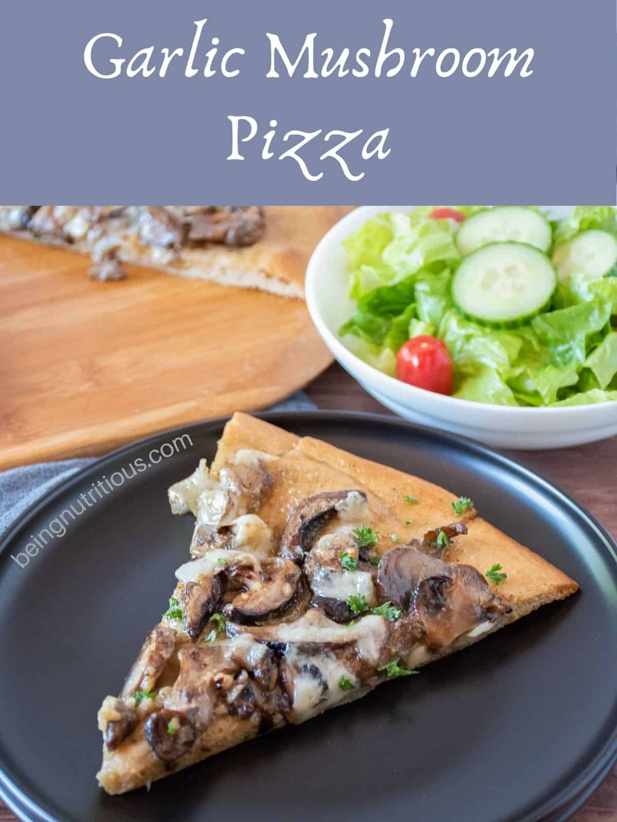 Slice of pizza on a plate, with a tossed salad in the background. Text overlay: Garlic Mushroom Pizza.