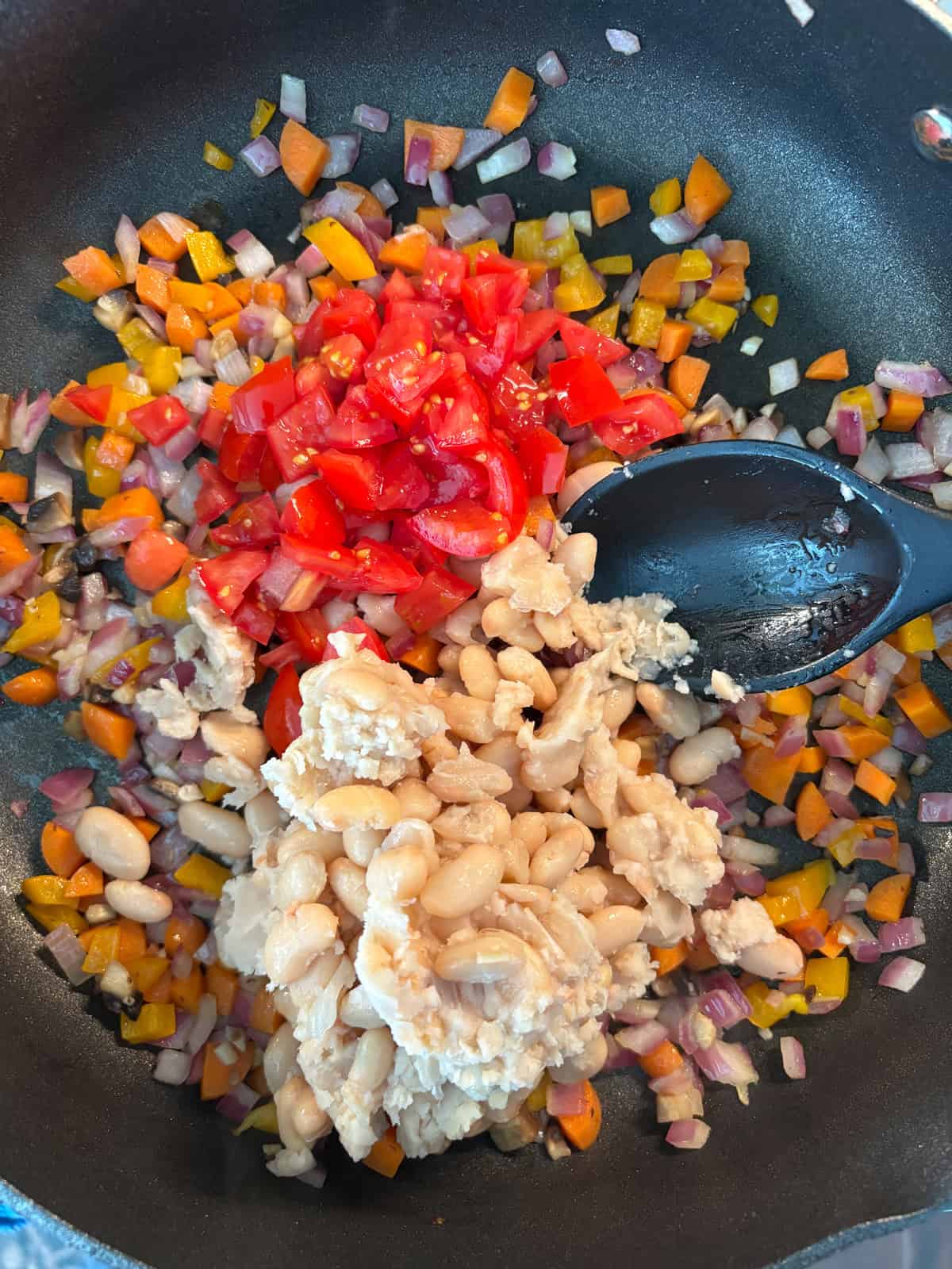 Beans and soft veggies added to sauté pan.