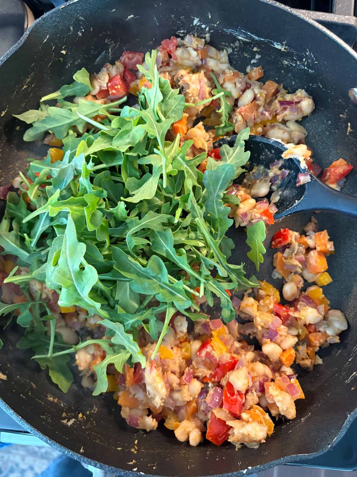 Greens added to the pan.
