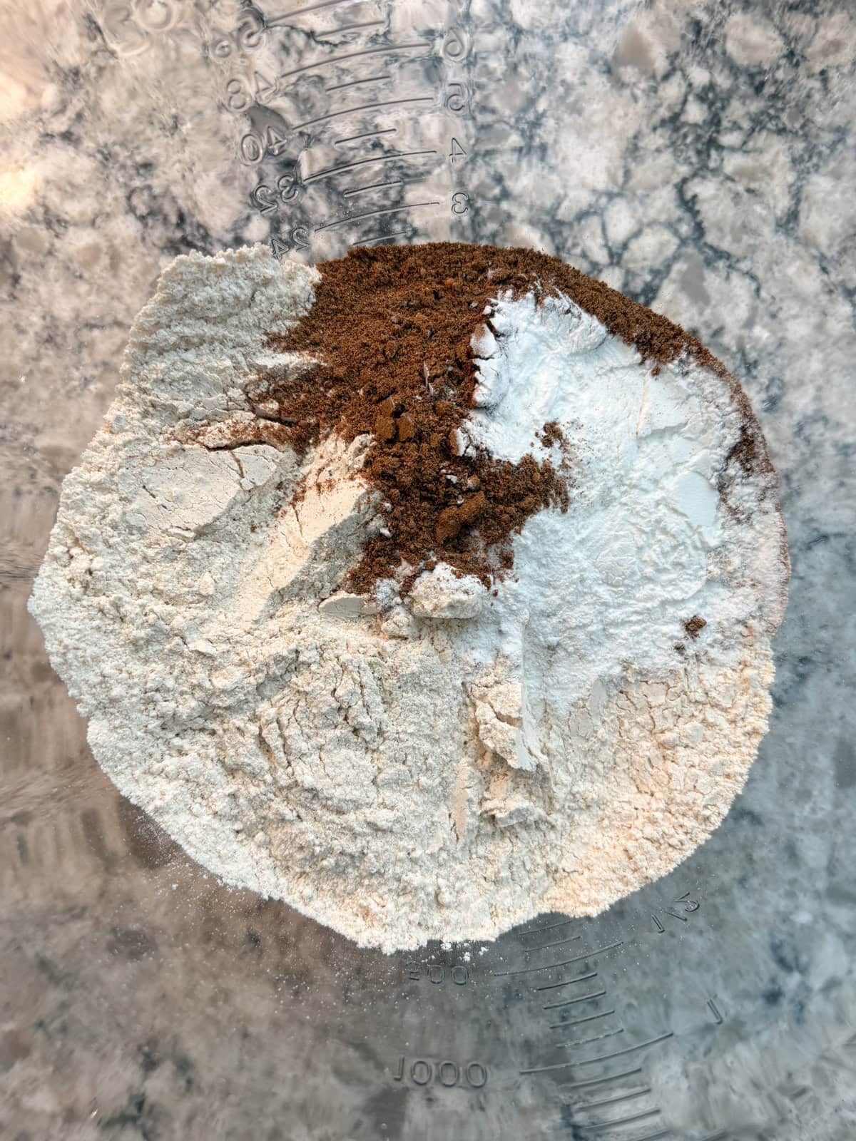Flour, baking powder, chai spice, and salt combined in a mixing bowl.