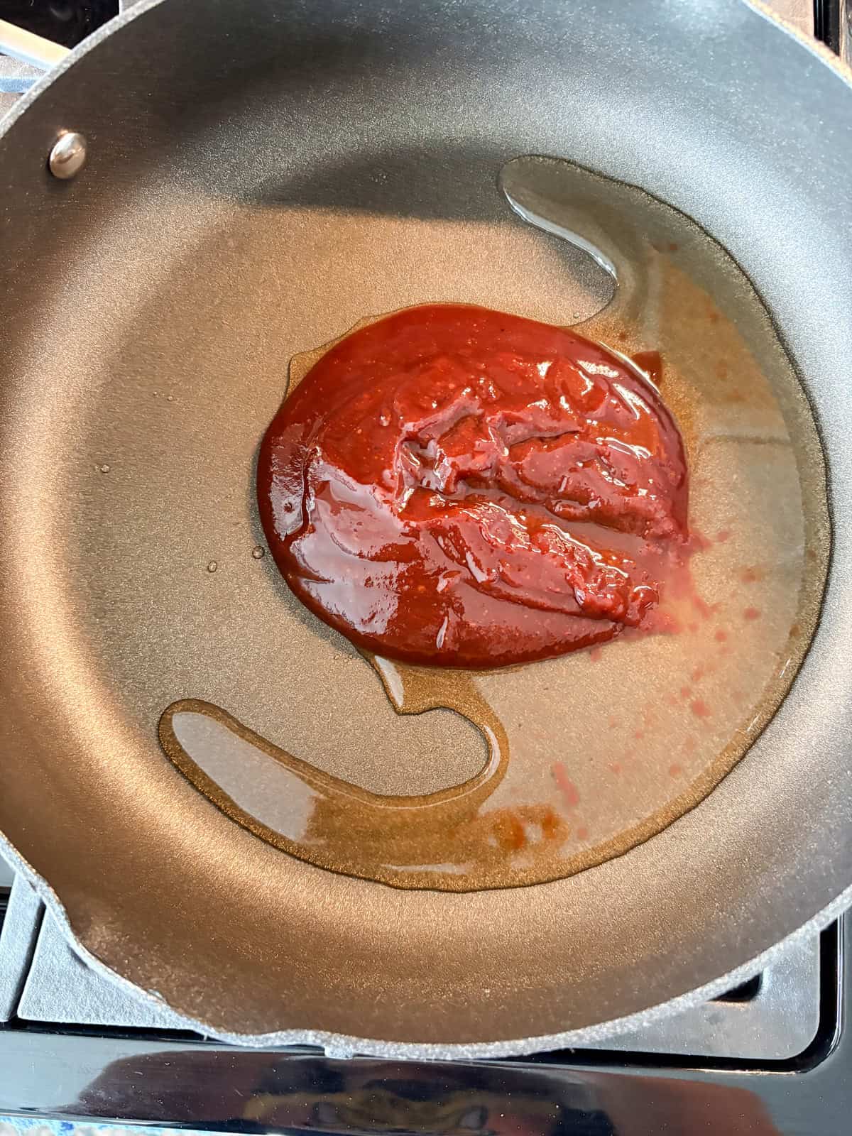 BBQ sauce and a little water added to a pan.