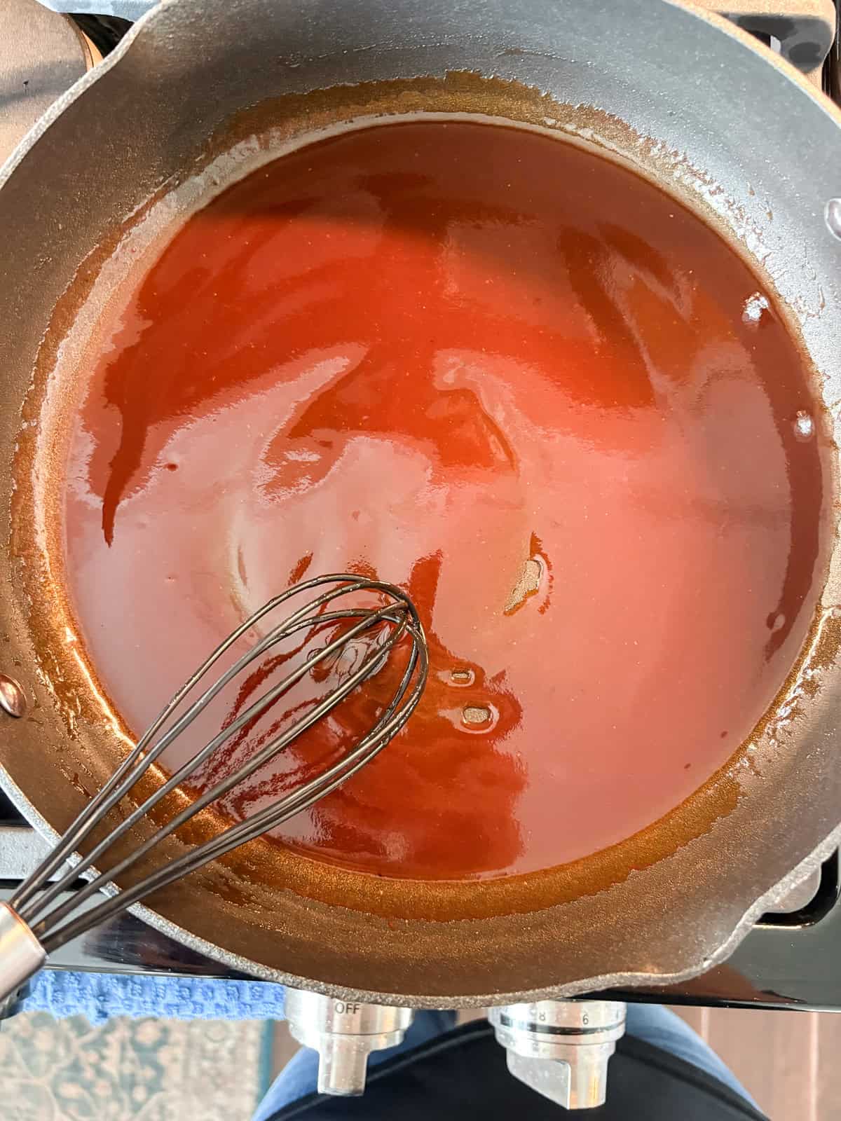 BBQ sauce warmed in a pan.