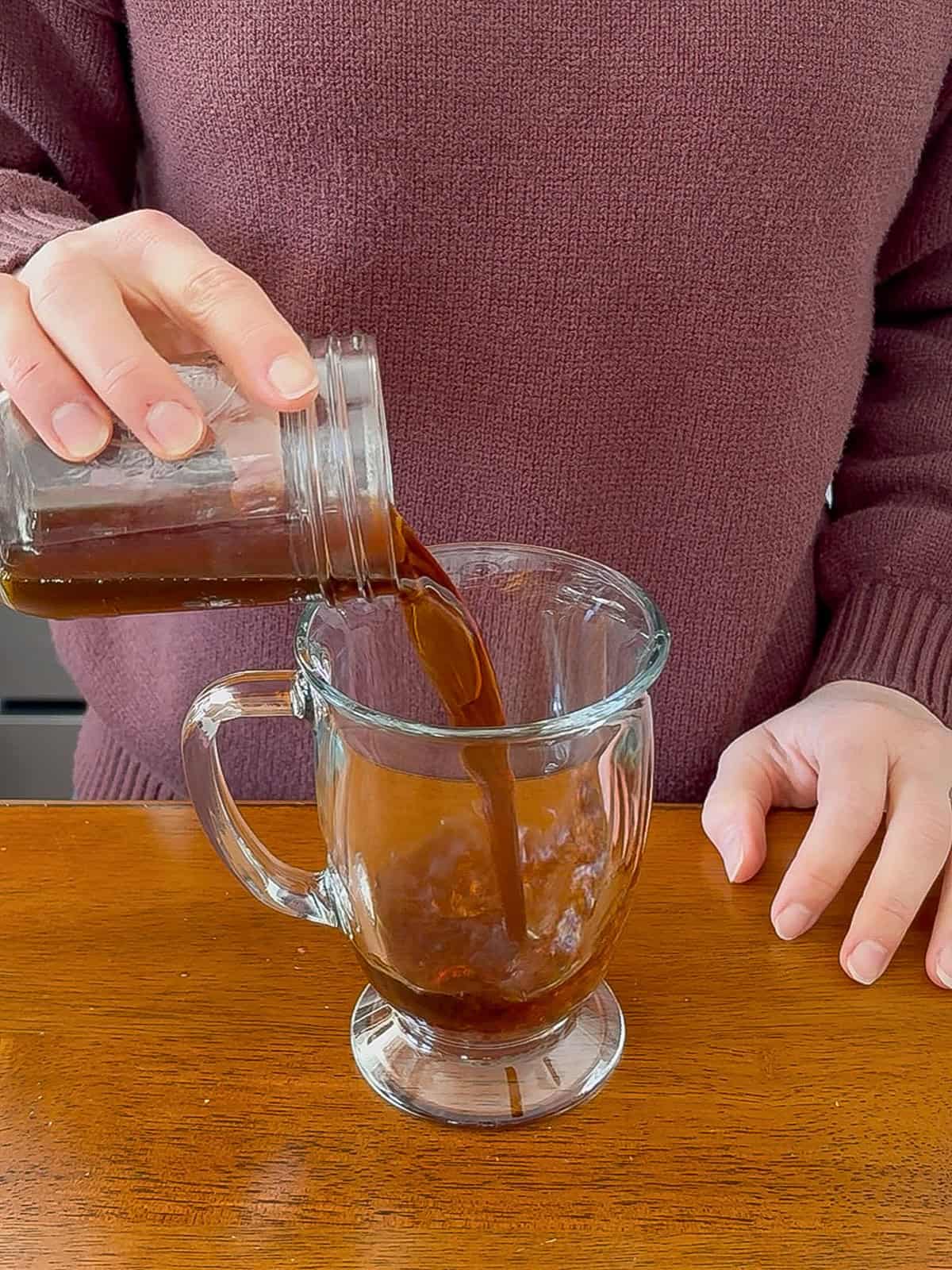 Pouring espresso into the mug.