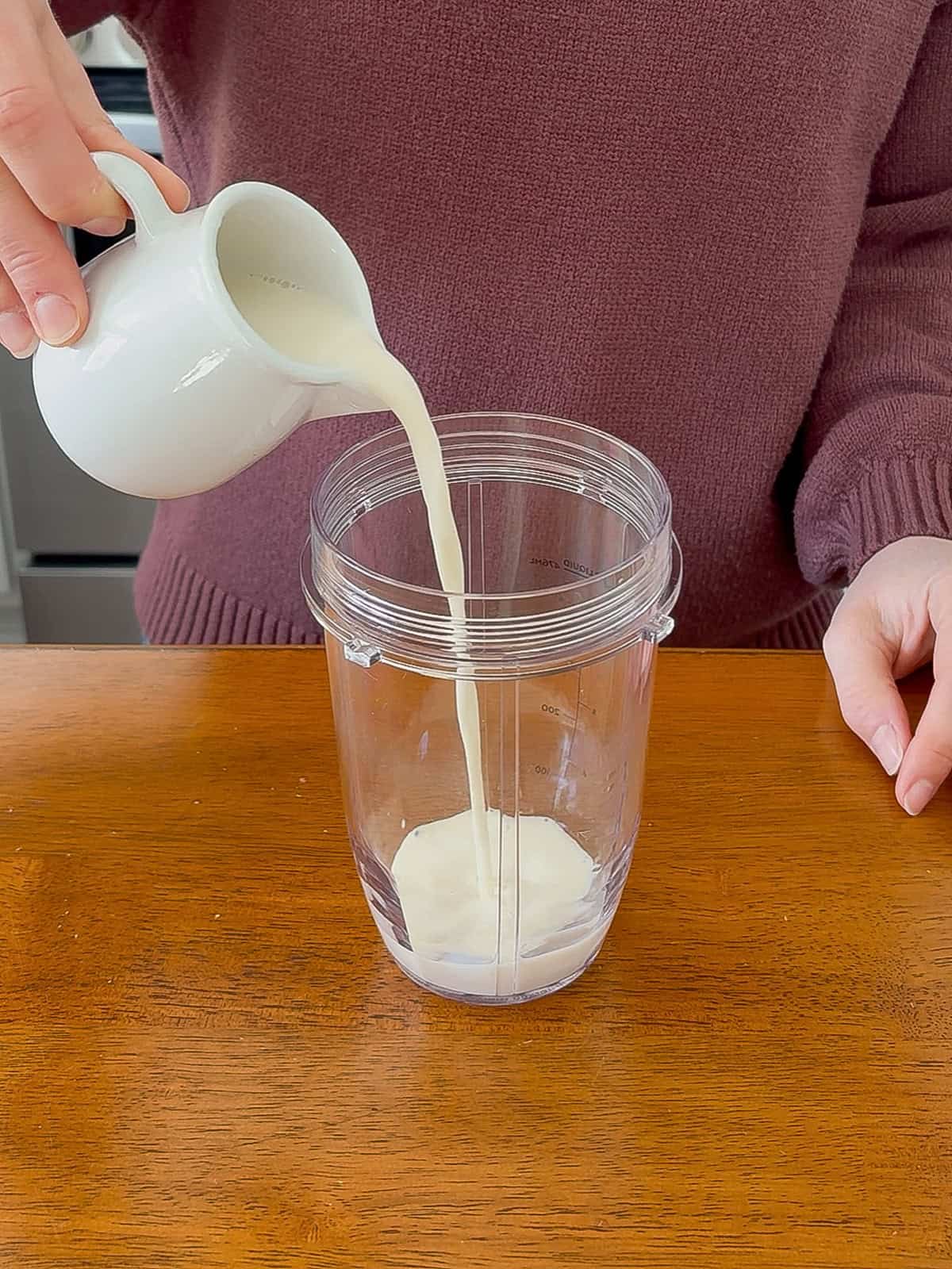 Pouring milk into the blender.