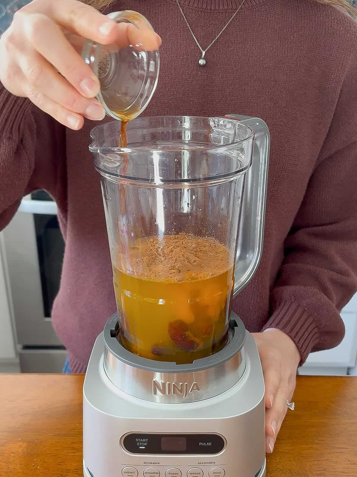 Adding vanilla to the blender.