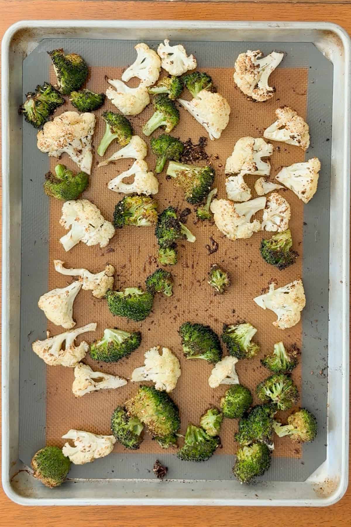 Roasted broccoli and cauliflower on a pan.