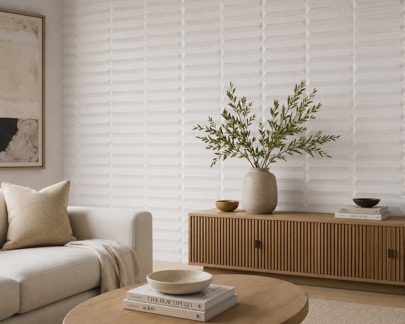White dimensional tile feature wall behind a low cabinet and living-room seating.