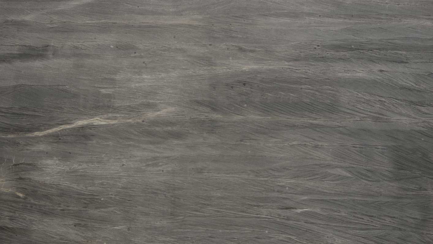 Dark gray stone surface with flowing lighter bands and fine pale veins.