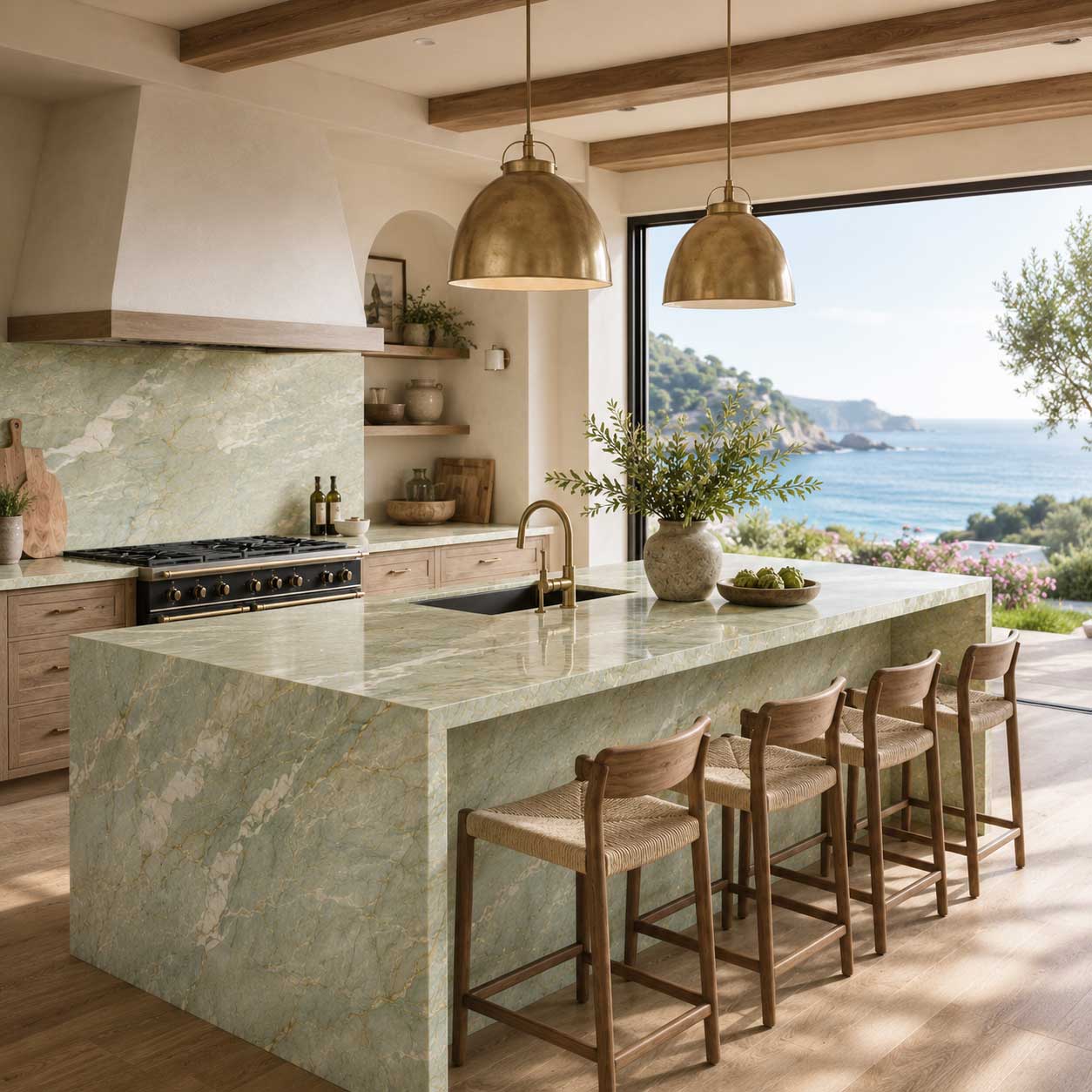 Kitchen with a pale green veined island, warm wood cabinetry and an ocean-facing window.