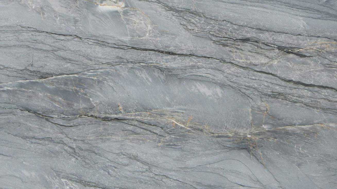 Wide view of a gray stone surface with sweeping diagonal veins.