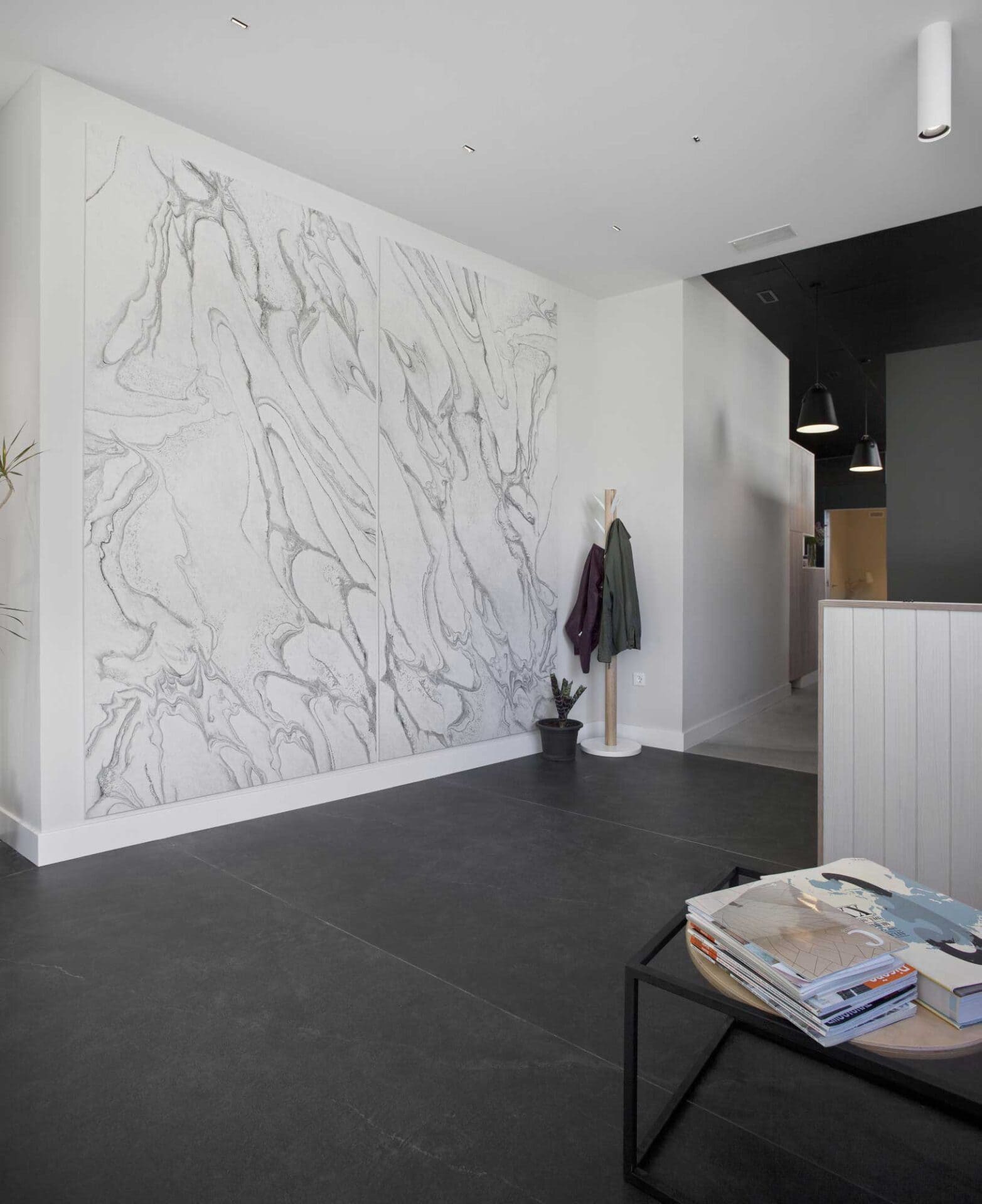 Modern interior with marble wall art and minimalist decor by Bella Pietra Design.