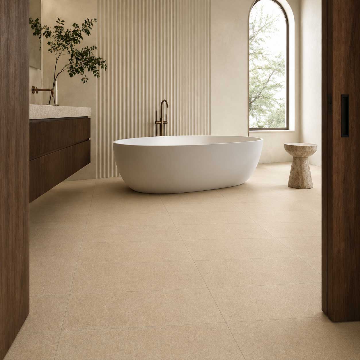 Bathroom with sand-colored floor tile, a freestanding bathtub and a ribbed feature wall.