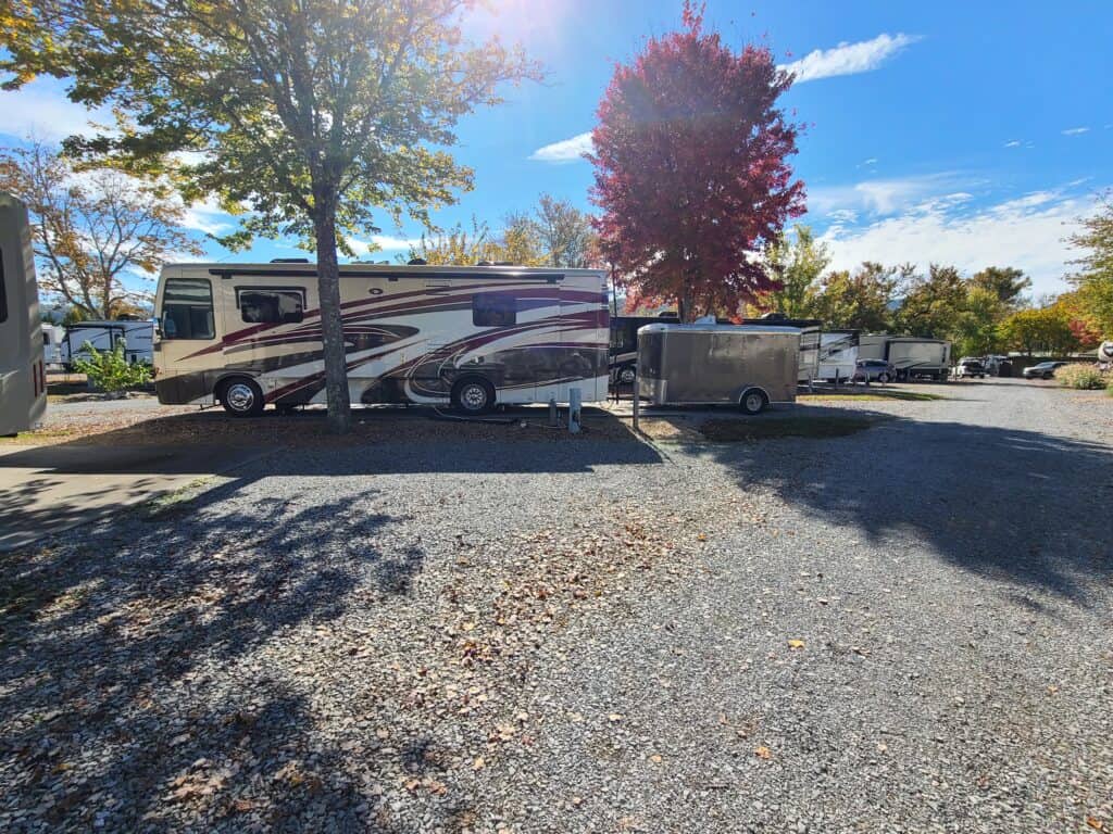 Big Rig Camping park with several rvs parked in a gravel lot.